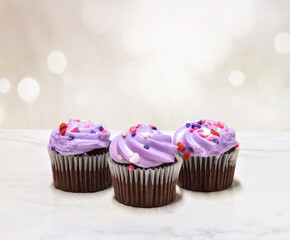 Cupcake mock up with purple frosting and sprinkles –plenty of copy space