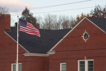 American flag in front of red brick building