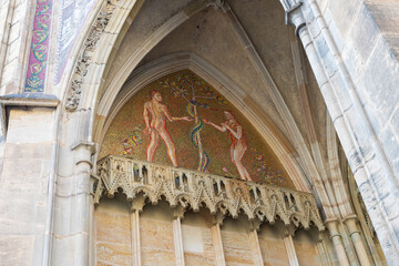 Mosaic  depicting Adam and Eve and the Serpent on the wall of the St Vitus Cathedral near the New Royal Palace in Prague in Czech Republic