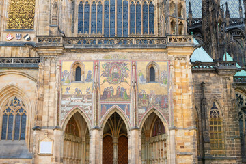 Religious  mosaics on the side wall of the St Vitus Cathedral near the New Royal Palace in Prague in Czech Republic