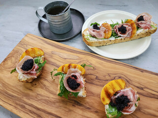Delicious homemade pastry. Smoked Rolled Bacon Baguette with Cream Cheese, Herbs and Black Caviar. Ideal for family gatherings
