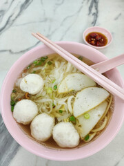 Authentic Teochew noodle meals. Homemade Fishball Noodle Soup. Fish paste ingredients from wolf herring or spanish mackerel fish and broth from anchovies and fish bones
