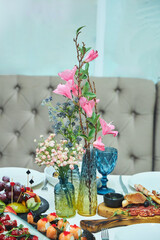 A table full of food and drinks with a variety of dishes and glasses. Scene is inviting and celebratory