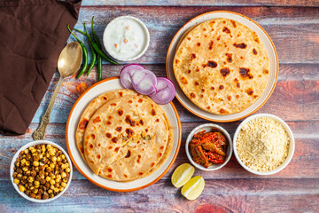Sattu paratha, a nutritious flatbread from Uttar Pradesh and Bihar, stuffed with roasted gram flour, served with pickle and raita.