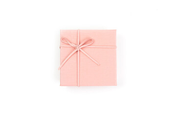 Top view, pink gift box tied with a bow isolated on white background. Gift box concept for a happy...