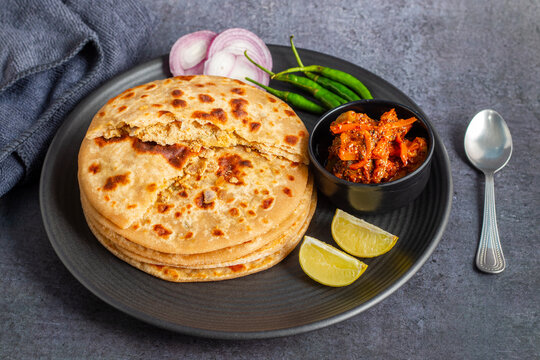 Sattu paratha is a flavorful flatbread from Uttar Pradesh and Bihar, filled with roasted gram flour, served with pickle and raita.