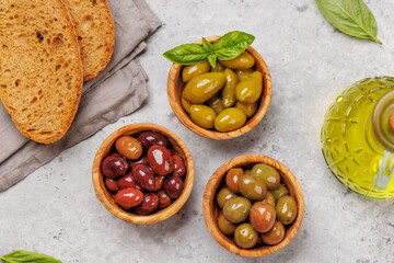 An assortment of various olives presented in a bowl, showcasing different colors, textures, and flavors