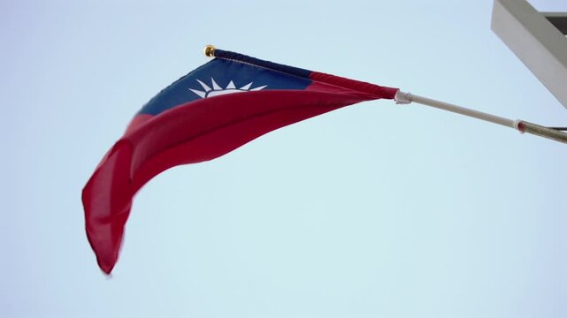 Slow motion of the Taiwan flag mounted on a street pole at dusk, highlighting pride and cultural identity. Perfect for urban and national themes.