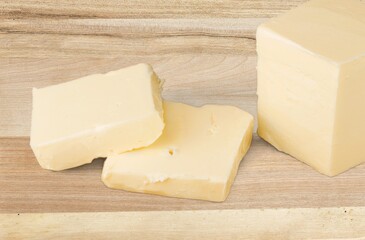 Sliced pieces of fresh butter on a table,