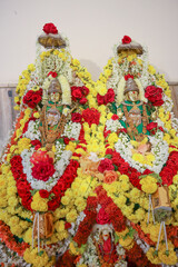 Gold colored Idols of Goddess Padmavati and Jwalamala divinely decorated with floral garlands at a...