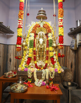 A Divine picture of a Gold colored Idol of Lord Parasnath in meditation posture at a Jain temple in Mysuru, India.