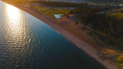 flying over the shore of Lake Baikal on Olkhon island at dawn