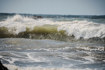 Closeup of waves crashing and sea foam on Pacific Ocean coastal shoreline Washington state