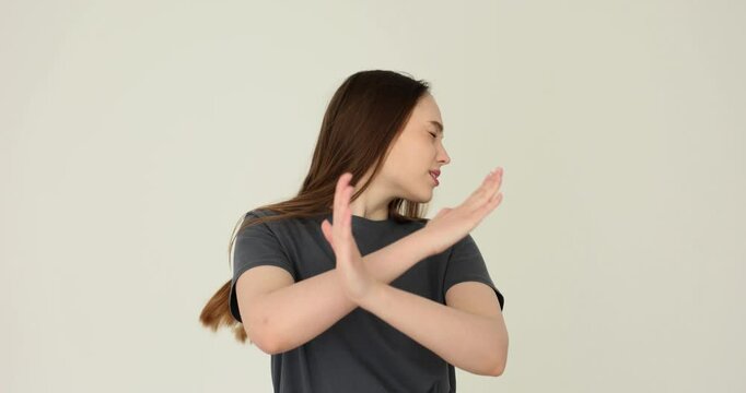 Woman stops gesture with hands on white background