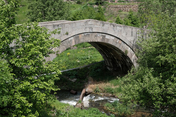 Typical medieval armenian bridge on a sunny spring day. Yaghdan village, Armenia.