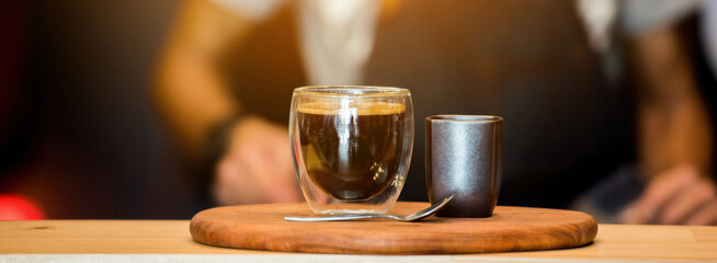 Banner coffee cup shot on wood table with copy space at retro coffee shop. Vintage hot black coffee fresh drinking espresso caffeine shot in morning.