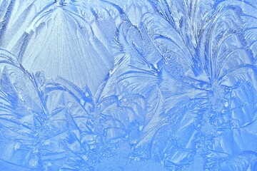Abstract patterns on the window from frost. Winter nature background.