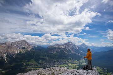 Naklejka premium Hiker enjoys the view from Tofana di Mezzo, in the italian Dolomites.
