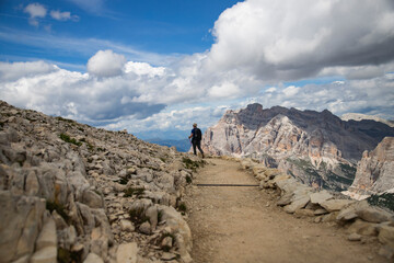 Hiker enjoys the view from Lagazuoi mountain over the italian Dolomites.