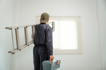 Fototapeta premium A skilled technician setting up high-quality blinds in a corporate boardroom, streamlined setup with professional tools, sunlight filtering in.