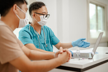 Doctor is giving advice on a disease to a male patient using a laptop computer.