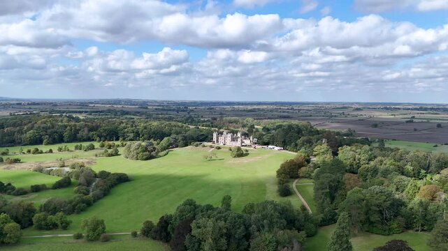 Mentmore Towers, Buckinghamshire, England - A Scenic View of a Mansion Nestled Amid Lush Greenery - Pan Up Shot