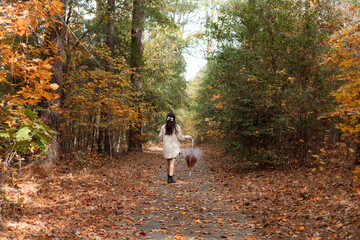 Fototapeta premium Woman enjoying a Fall walk in the forest