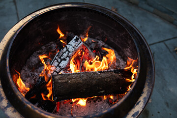 close-up of fire in a fire pit outside in fall