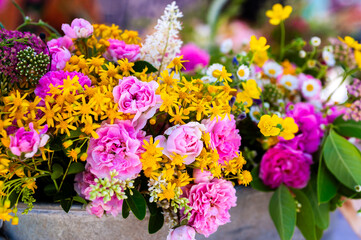 A bouquet of fresh mixed flowers in a container.