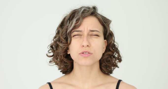 Woman squints to see and poor vision on white background