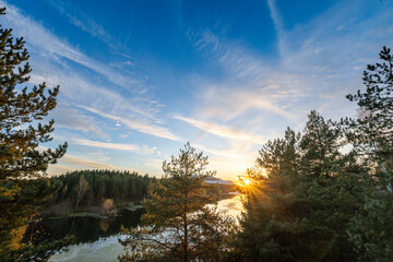 A beautiful blue sky with a few clouds and a sun in the background
