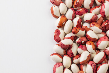 Food background with red and white kidney beans on white  with copy space