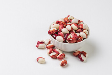 Red and white  kidney beans in white bowl on white background isolated