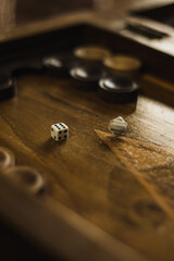 Backgammon Board with Dice and Spinning Piece - Close-Up Shot of Traditional Board Game in Warm Lighting - 2