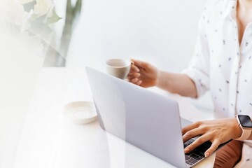 Businesswoman drinking coffee while working at home