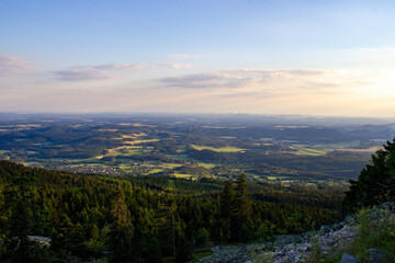 a breathtaking view of the natural beauty of green forests from a high mountain