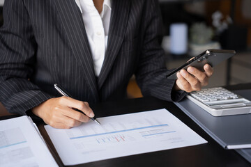 Fototapeta premium Asian Business woman using smart phone spending time checking news social media