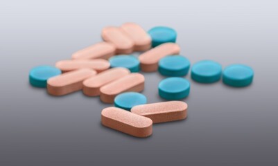 Pills medical capsules in different colors on desk