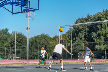 Boys participate in outdoor basketball training with a coach, focusing on teamwork, skills development, and building athletic confidence in a supportive sports environment