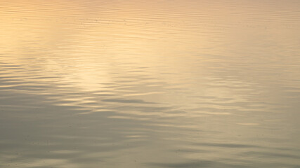 A tranquil sunset over calm waters, evoking serenity and reflection, perfect for concepts of peace and relaxation