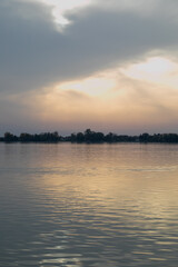 Tranquil sunset over a calm lake captures serenity and reflection, ideal for relaxation and mindfulness concepts