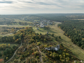 Aerial drone view of Mirow Castle in autumn. Jurassic limstone rocks on Eagles Nests in Polish Jurassic Highland. Old medieval fortress, royal castle in the village of Mirow, Poland.