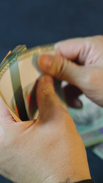 Cashier counting malaysian ringgit banknotes