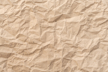 Background or Wallpaper of crumpled brown paper texture that looks like it has been used before. ideal for crafts needing an organic and textured feel that require a classic, retro or vintage.