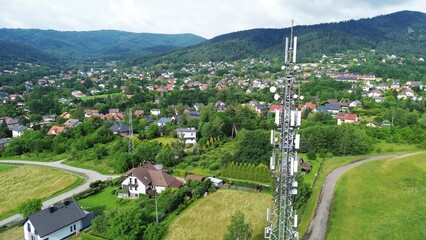 High antenna tower in rural town with scenic highway view
