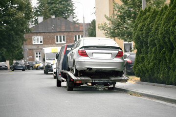 Car accident recovery with tow truck in street