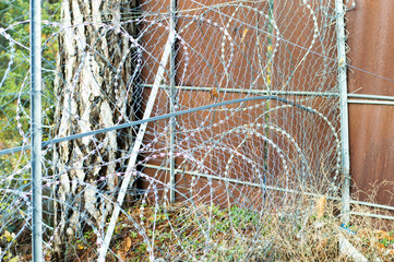 close up of barbed wire. Abandoned building. Prohibit protected area.