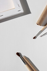 Hobbies. Canvas, Painting Brushes, Graphite Pencil, Kraft Paper Flatlay on White Background. Artist, Illustrator, Painter Workplace.