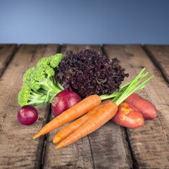 Fresh ripe vegetables and fruits on wooden desk
