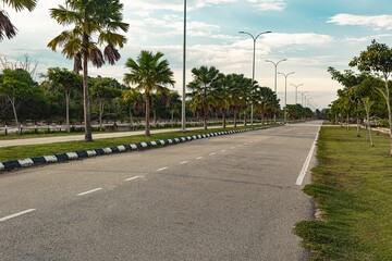 Beautiful view of rural road with space in middle. Most beautiful road in broad daylights, trees, blue sky in spring with nature background in Malaysia